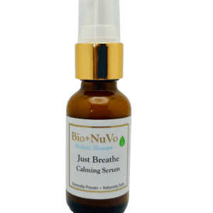 A bottle of just breathe calming serum on a green background.