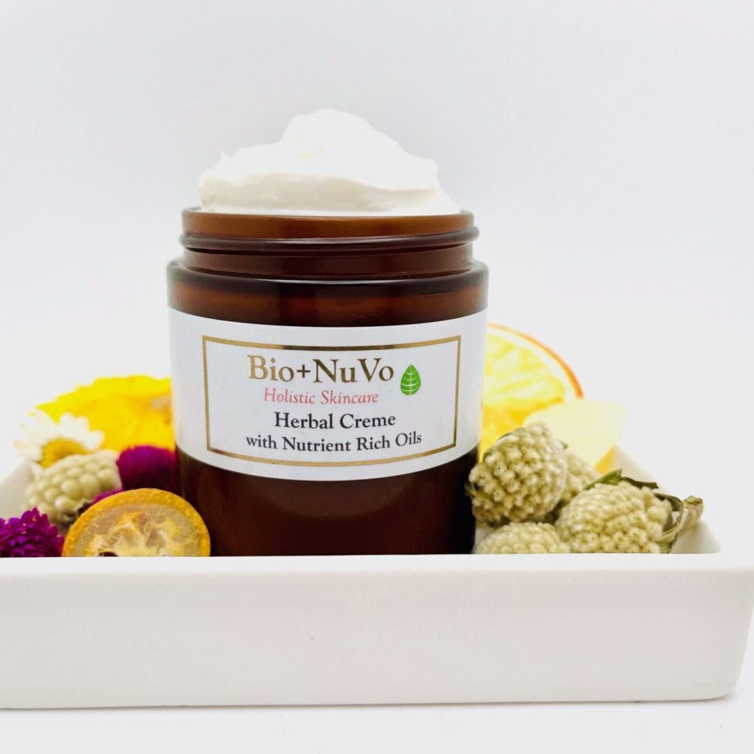 A jar of body butter sitting on top of a white tray.